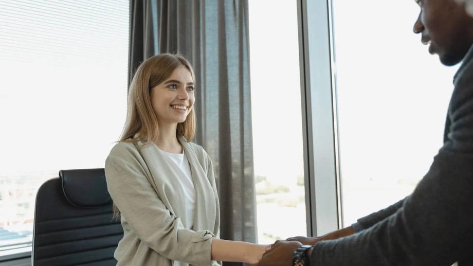 An employer shaking hands with a new member of staff